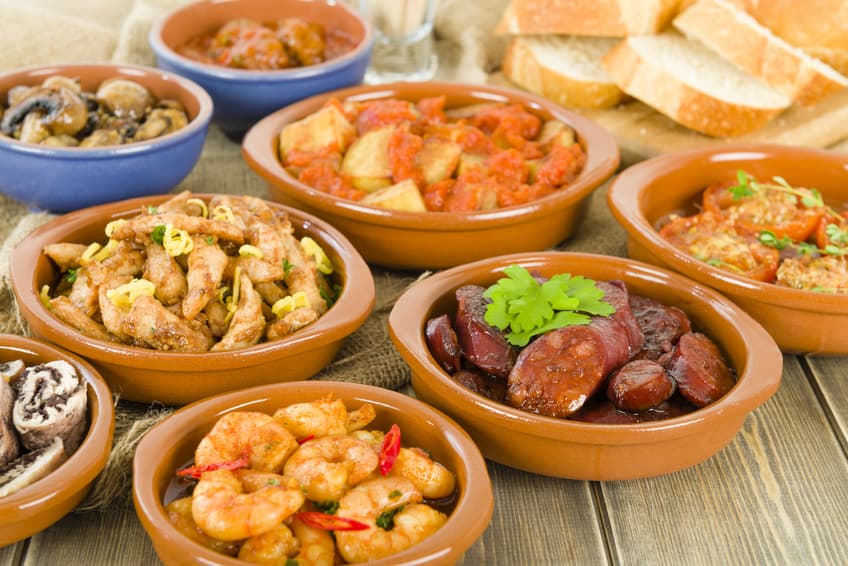 Tapas in Tonschalen mit Garnelen, Chorizo, Hähnchen und Pilzen
